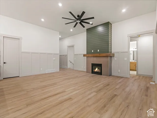 Wood-finish flooring, recessed lighting, and a modern ceiling fan