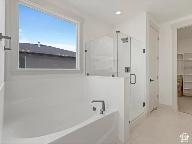 White soaking tub with matte black fixtures
