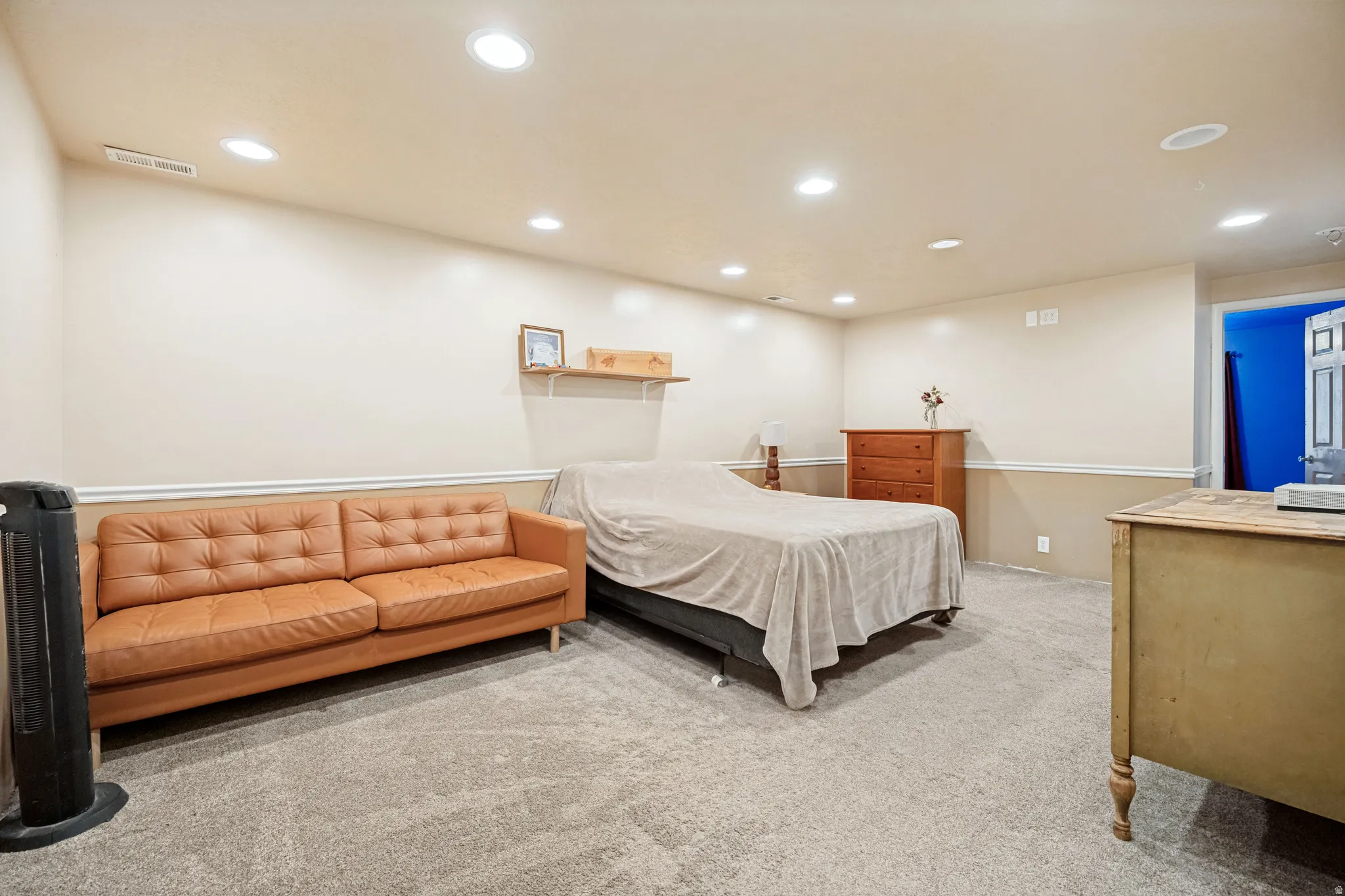 Spacious room featuring neutral carpeting, recessed lighting, and a two-tone wall finish with chair rail molding