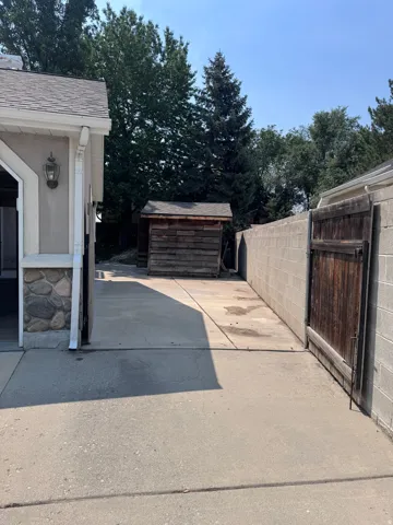 Paved driveway and walkway with a detached storage shed