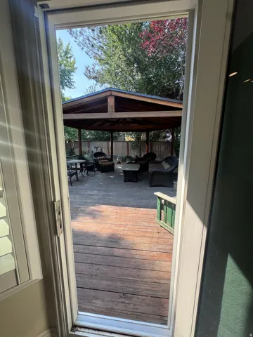 Expansive wood-finish deck featuring a substantial wooden gazebo