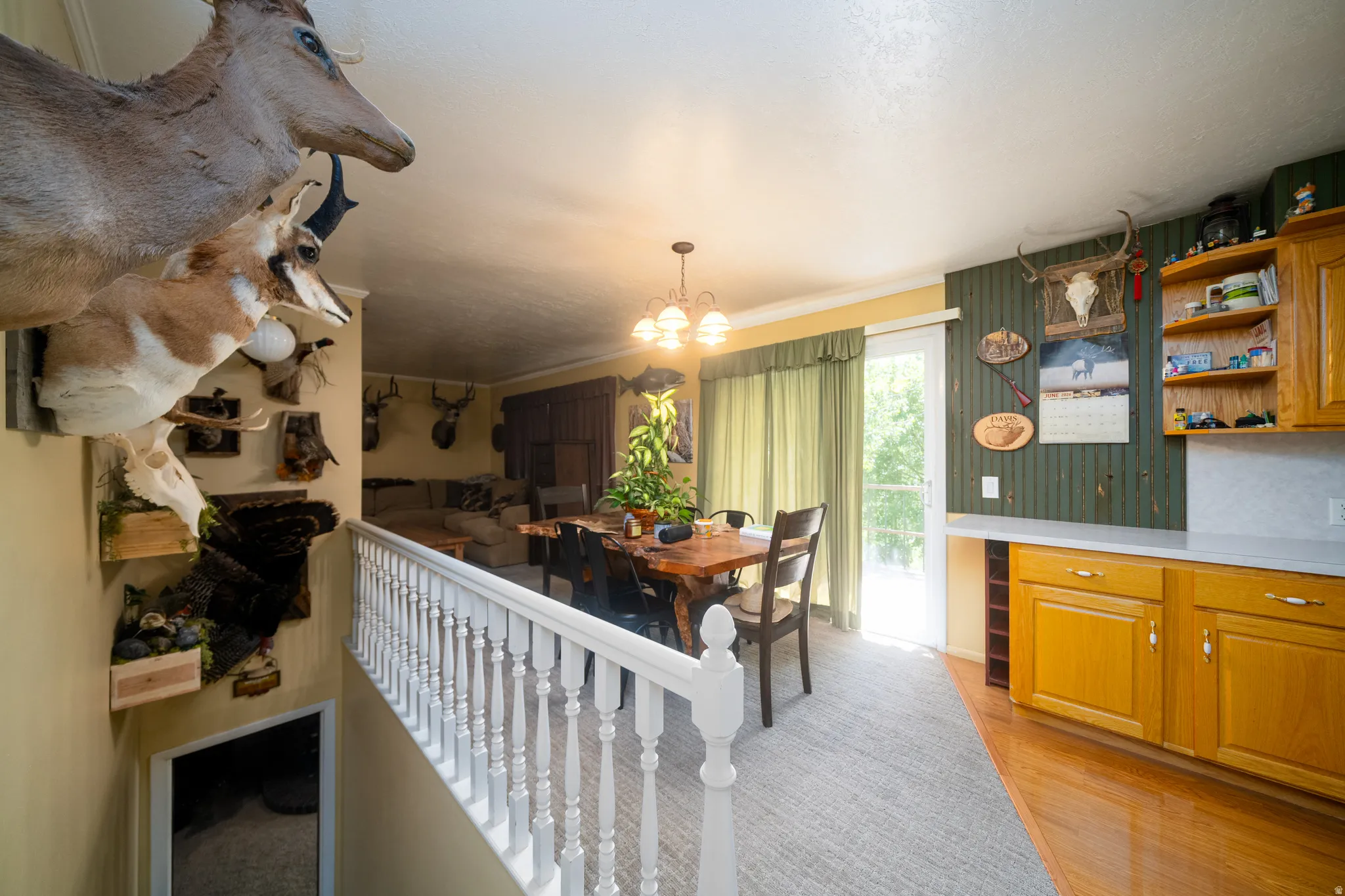 Dining area featuring a wood-finish table, chandelier lighting, and direct outdoor access
