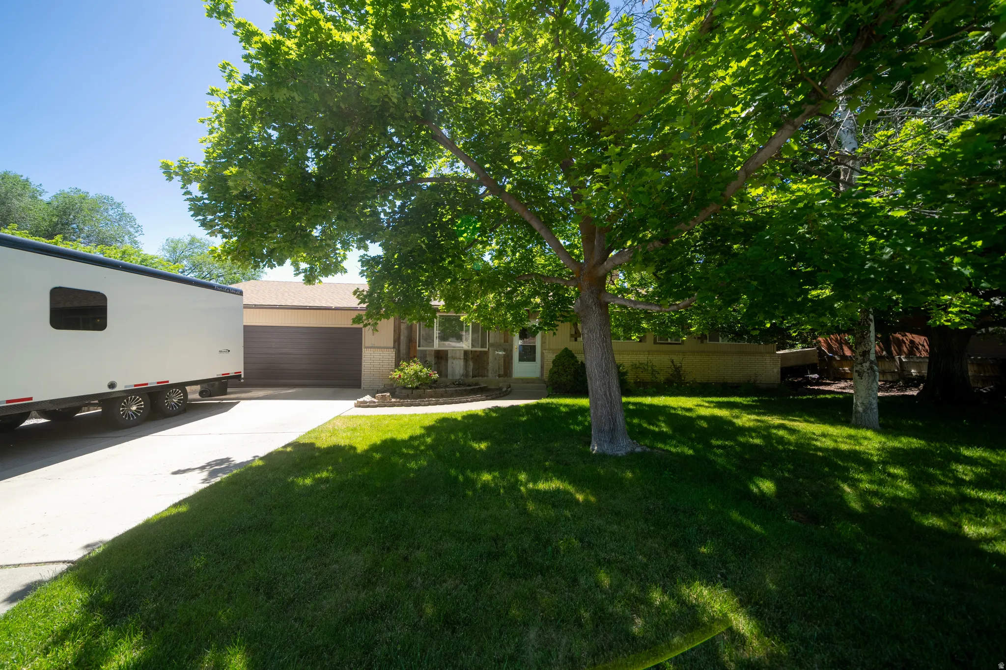 Ranch-style residence featuring a brick facade and an attached two-car garage