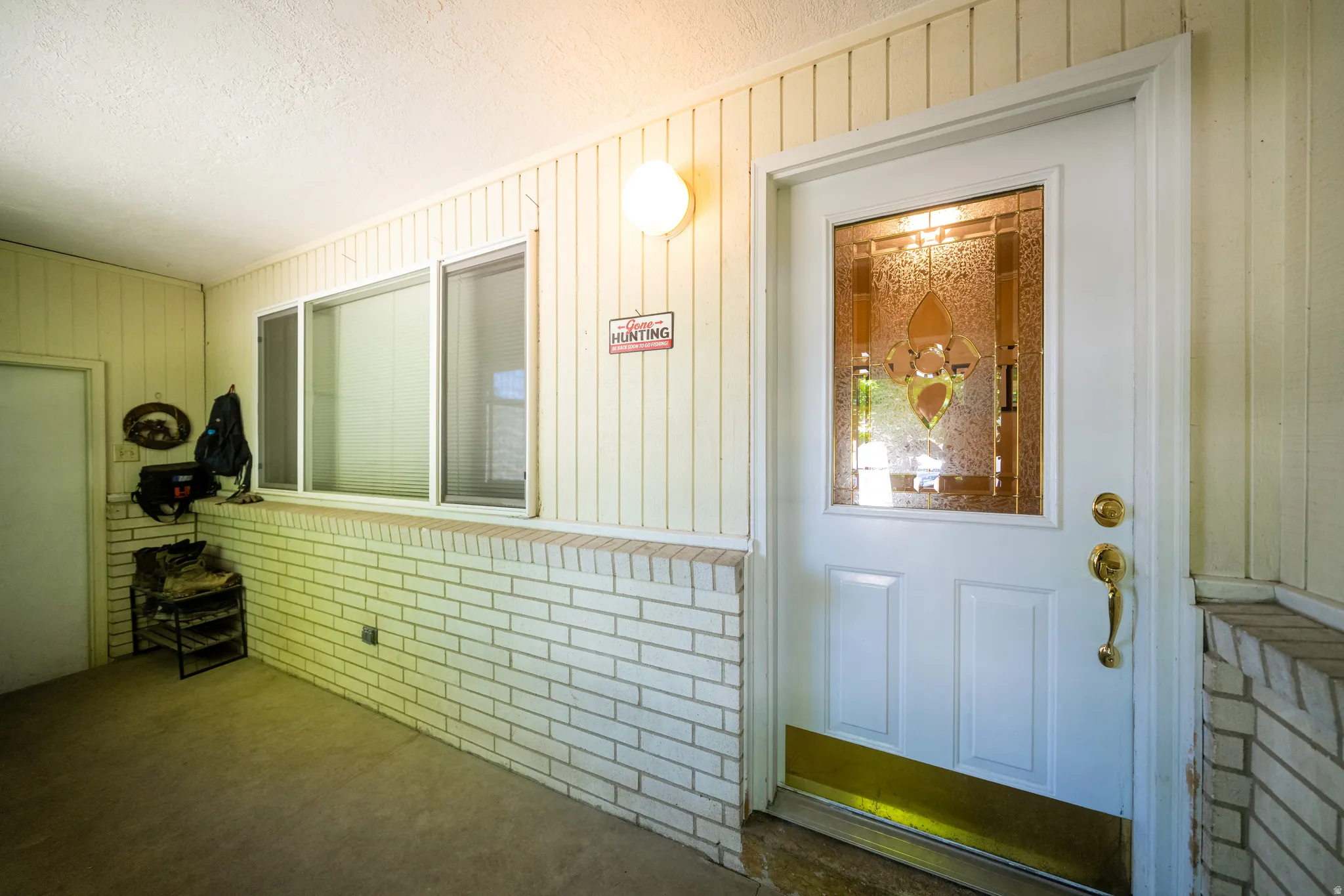 Entry door with decorative glass insert and brass hardware