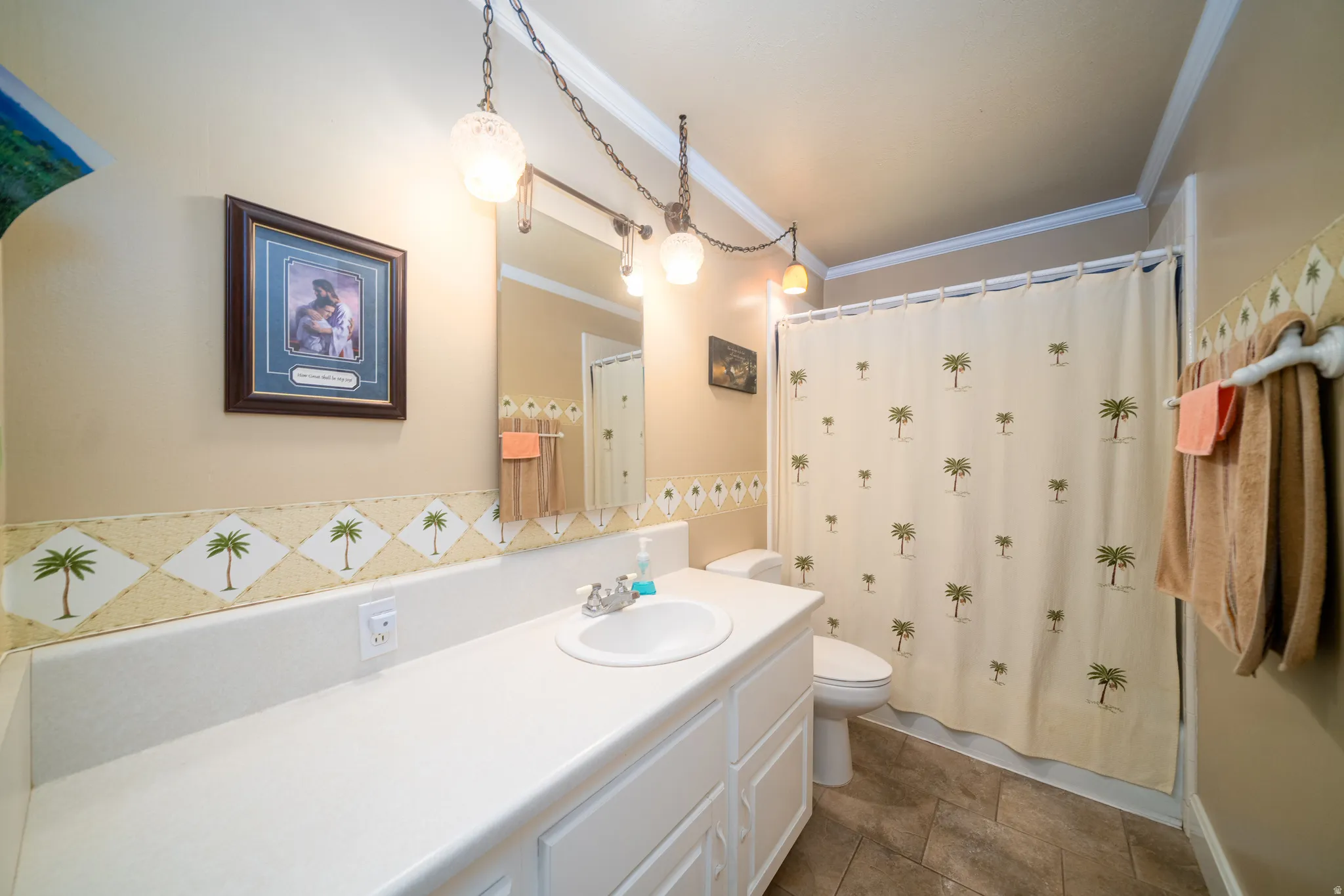 Bathroom featuring an extended vanity with an integrated sink, a toilet, a shower area with a curtain rod, and ceramic tile flooring