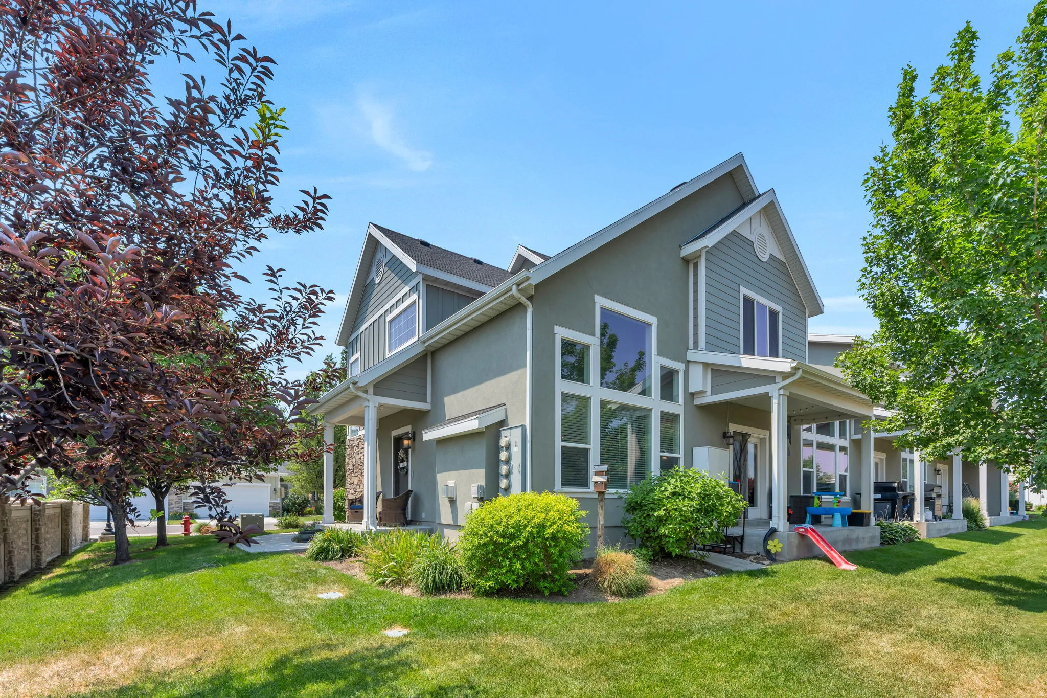 Two-story townhome featuring a stucco and siding exterior with gabled architectural details
