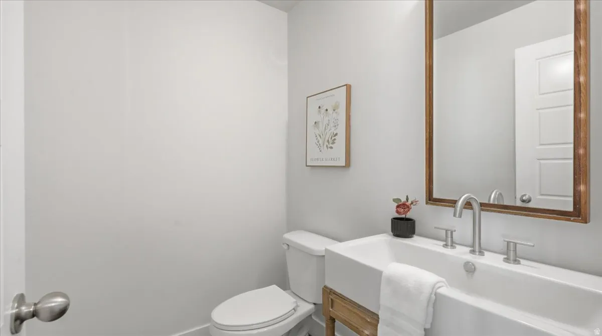 Bathroom with a rectangular vessel sink featuring a single-handle faucet and two-handle controls