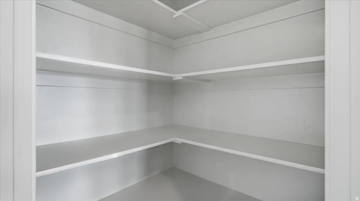 Interior closet featuring multiple white painted shelves