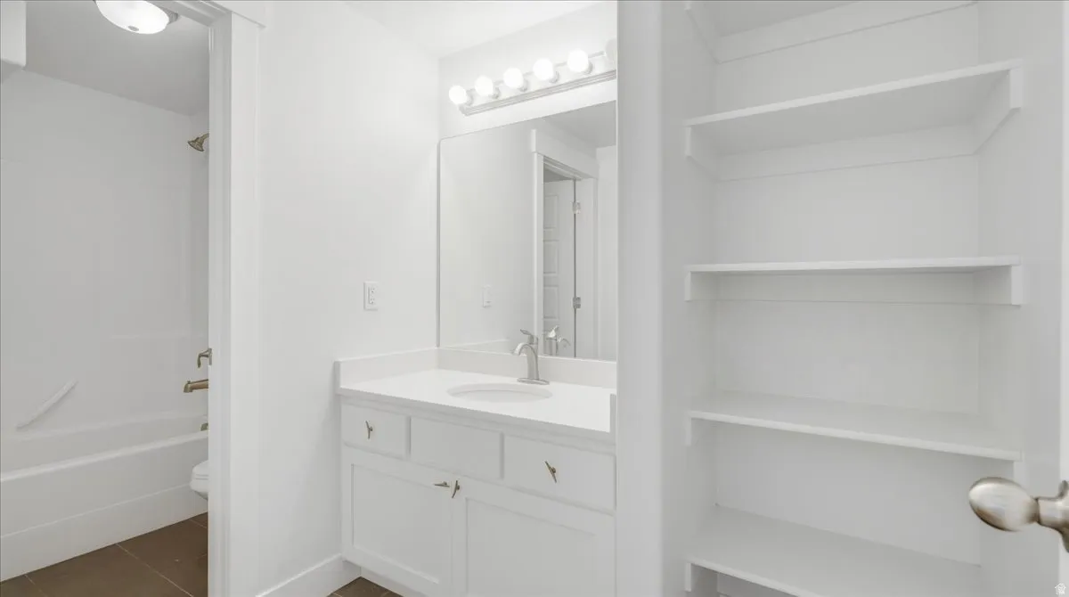 Bathroom vanity featuring a single sink, light-toned countertop, and a medicine cabinet mirror