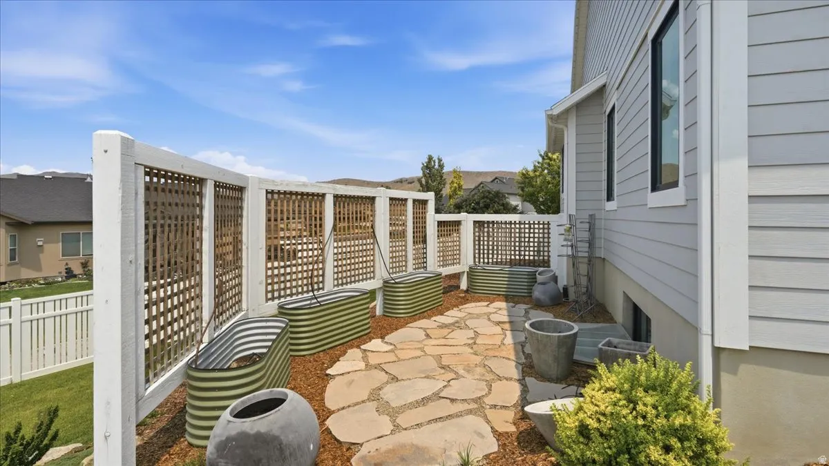 Outdoor patio featuring flagstone paving and raised garden beds
