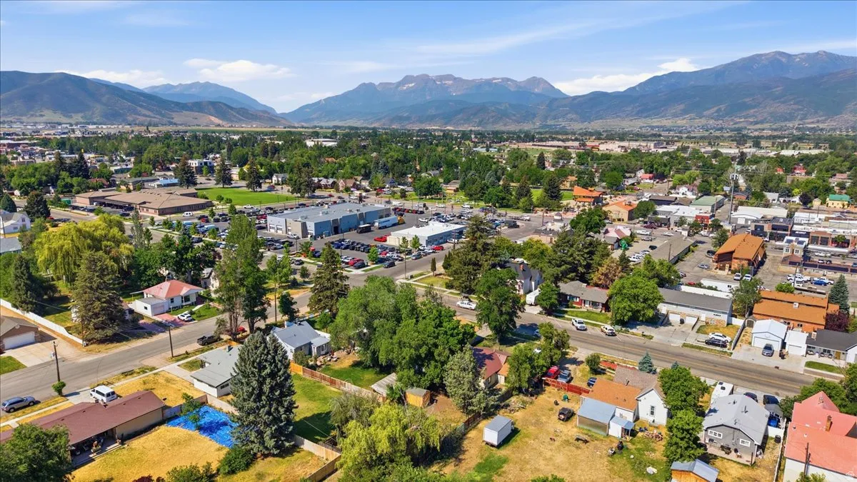 Expansive aerial perspective showcasing a community nestled against a mountainous backdrop