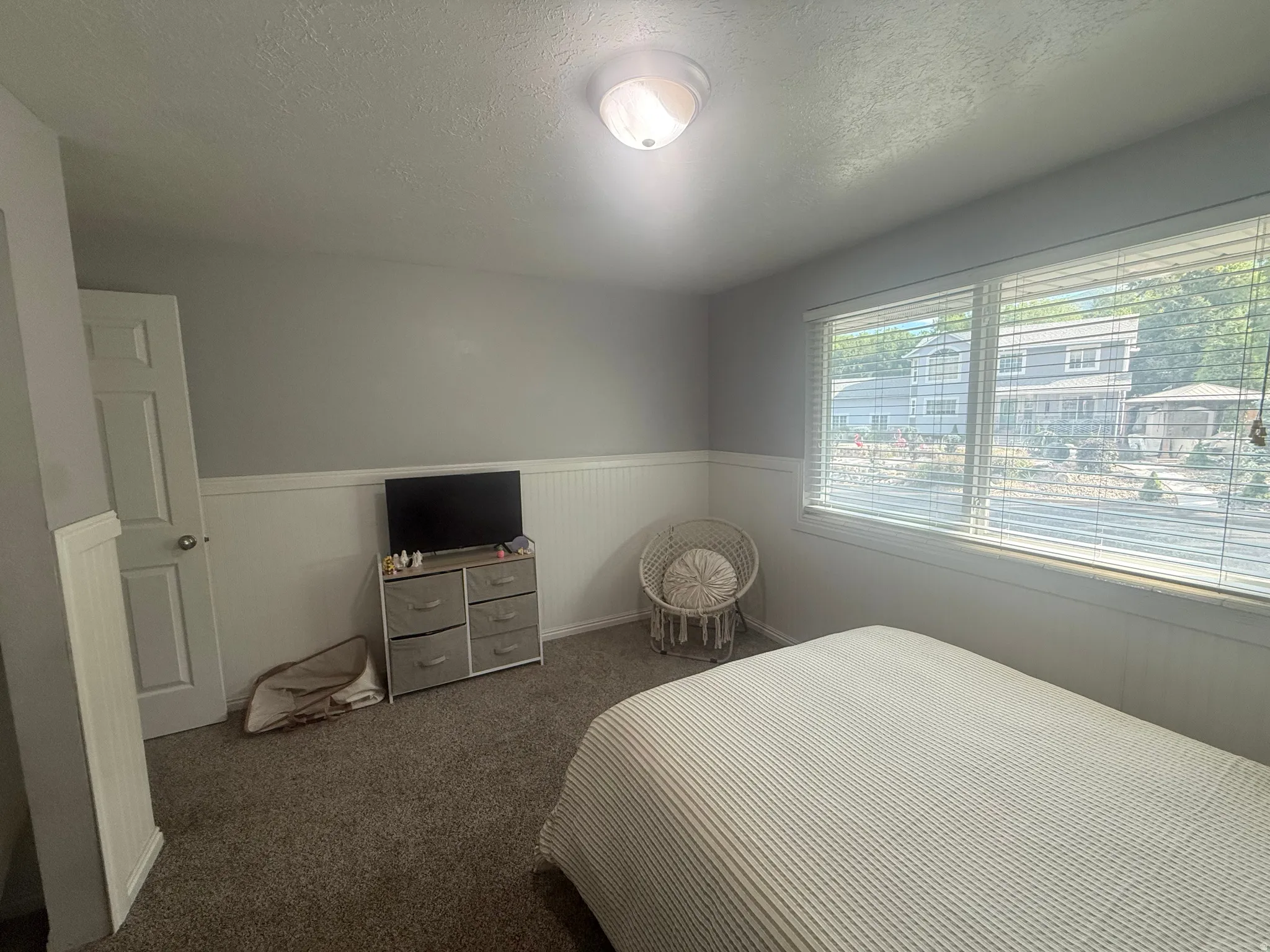 Wall-to-wall carpeting and neutral wall tones define this interior space