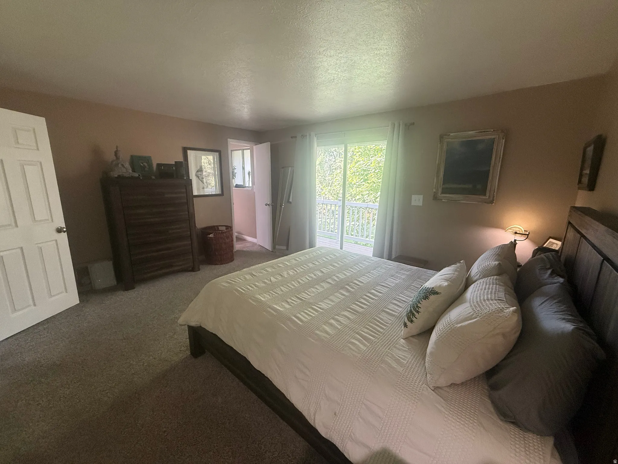 Spacious room featuring carpeting and a private balcony with white railings