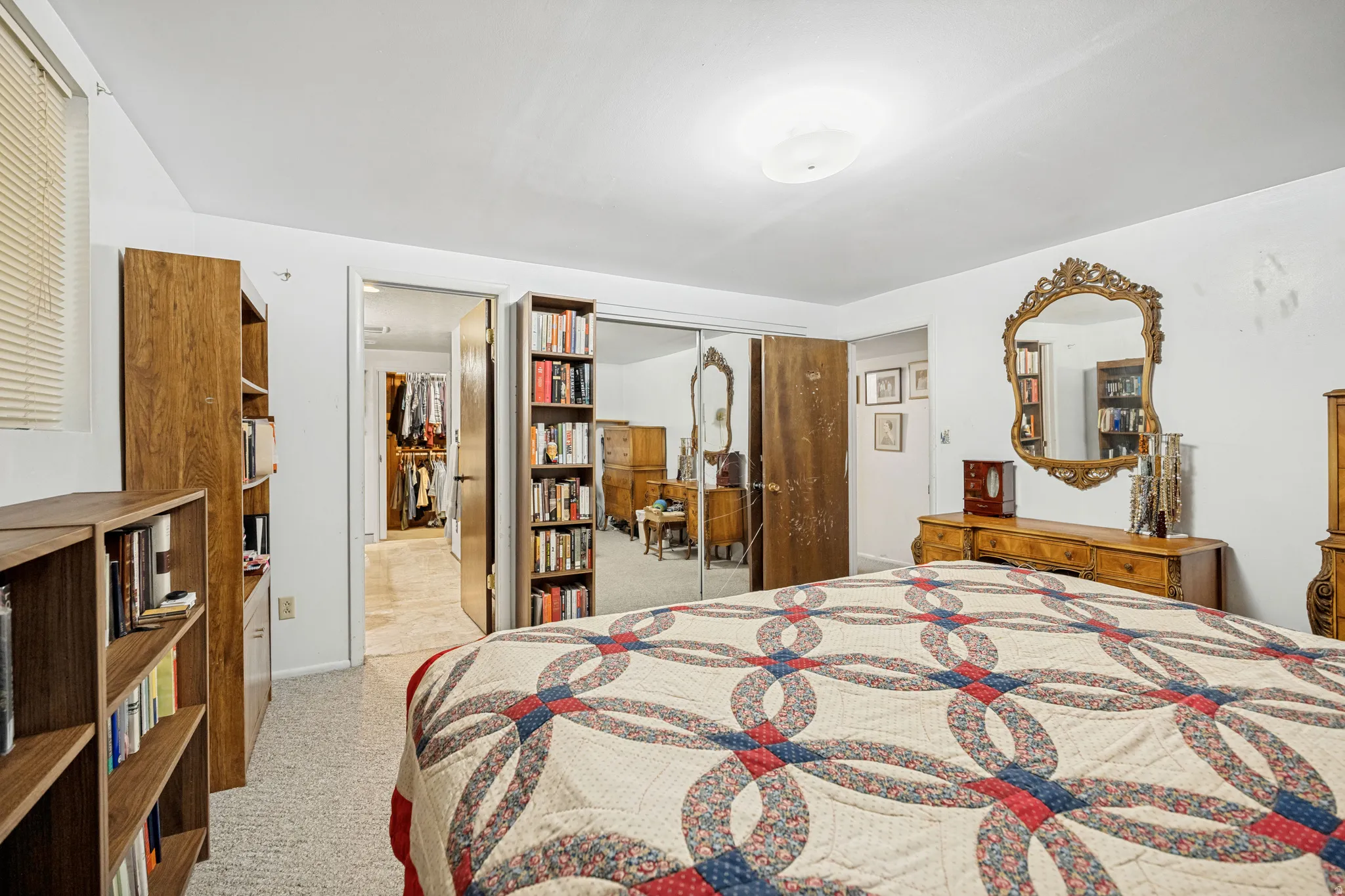Bedroom featuring light-colored carpeting, white walls, and a ceiling-mounted light fixture