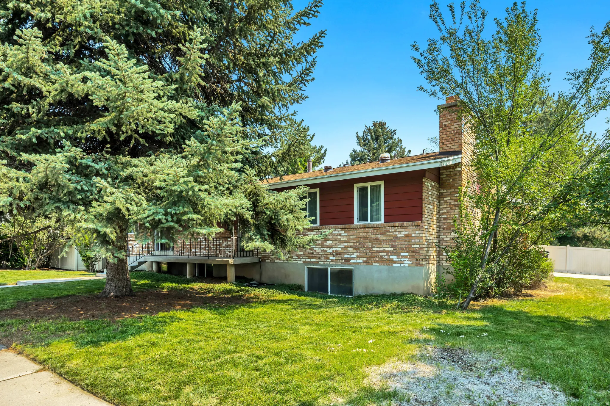 Brick and siding exterior with mature trees