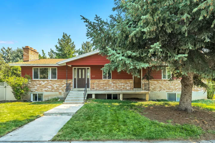 Ranch-style exterior with red siding and light-toned brick accents