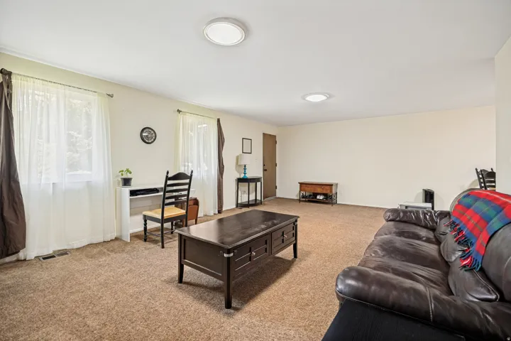 Spacious room with neutral wall tones and plush carpeting