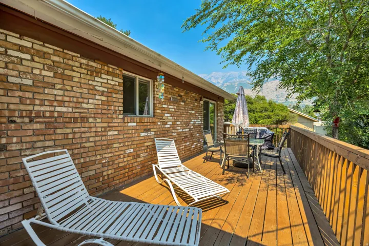Spacious outdoor deck featuring wood flooring and a perimeter railing