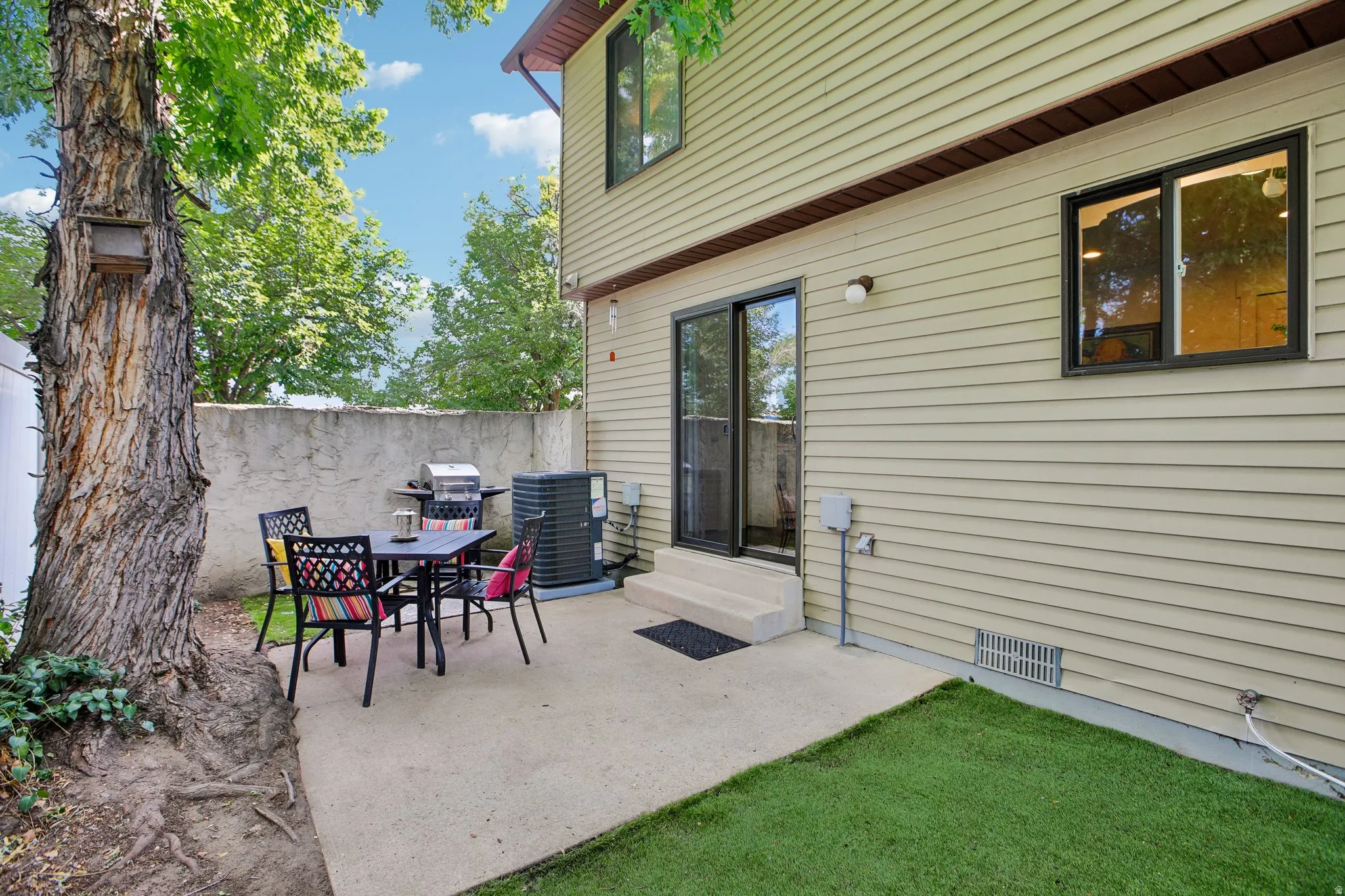 Private concrete patio featuring a sliding glass door entry