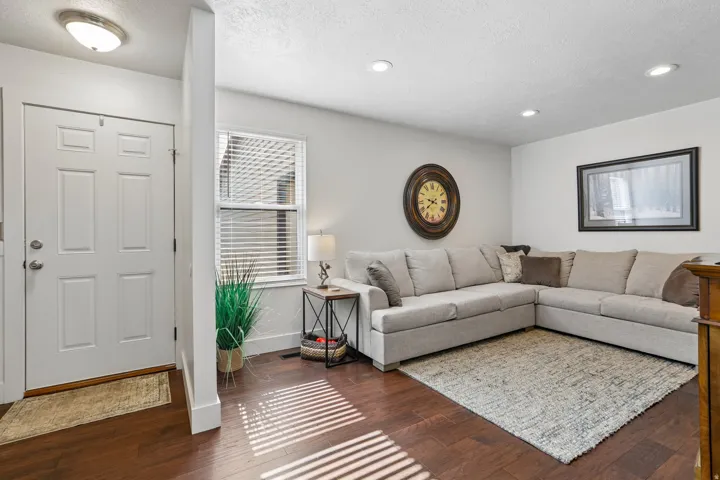 Warm-toned wood-finish flooring extends throughout this space
