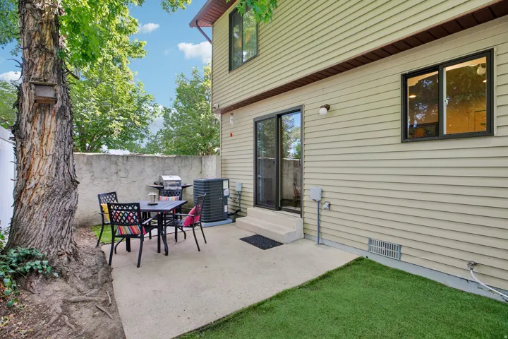 Private concrete patio featuring a sliding glass door entry
