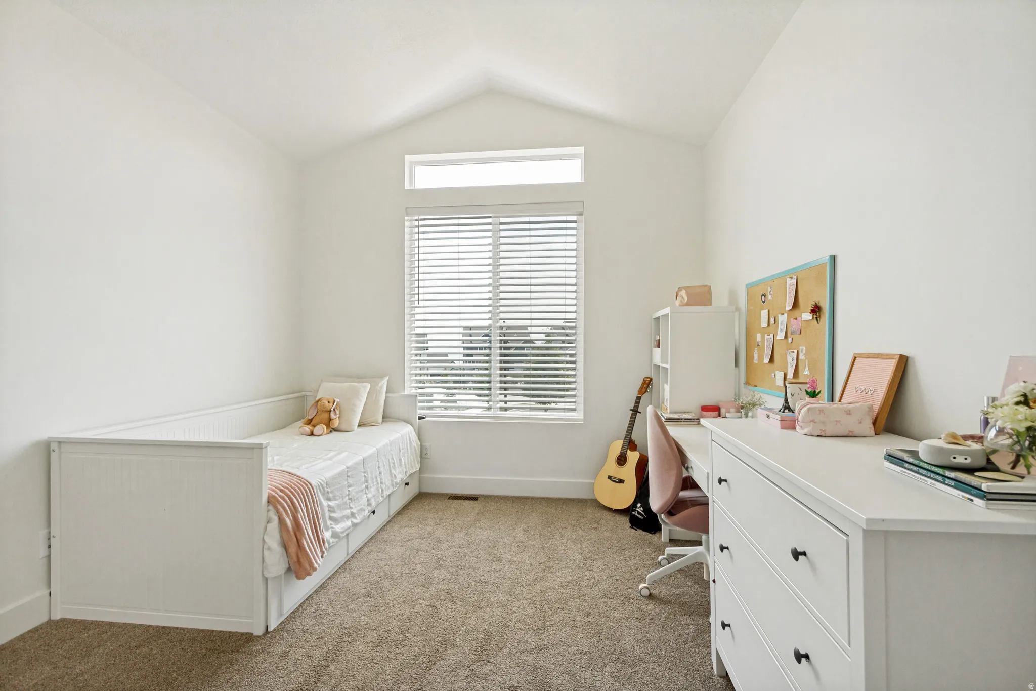 Interior room featuring a vaulted ceiling and an upper transom window