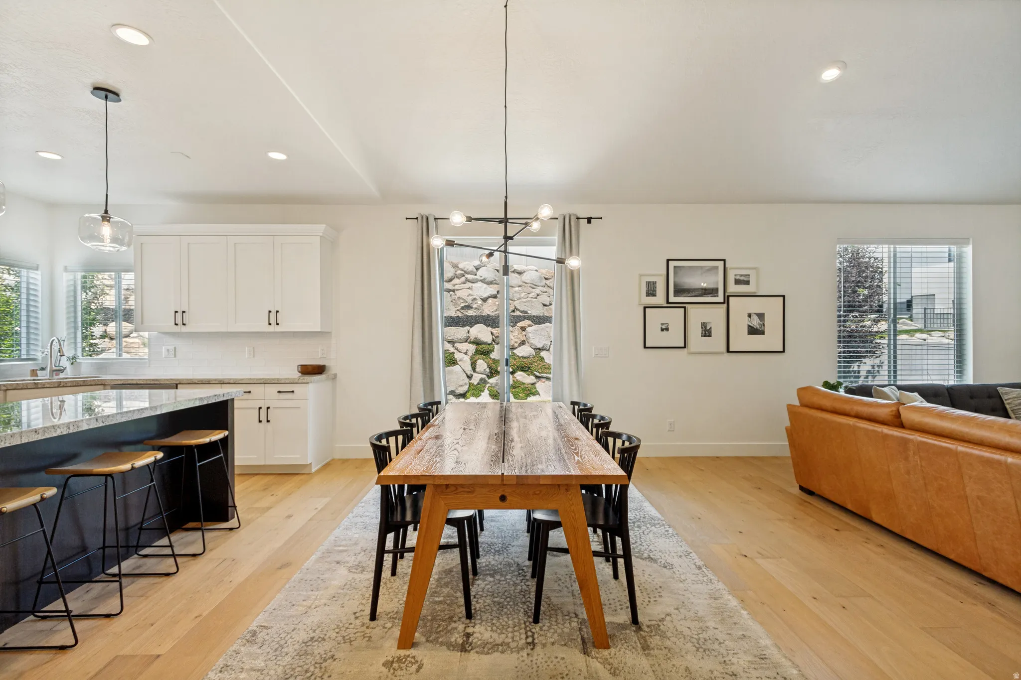 Spacious open-concept interior featuring light wood-finish flooring