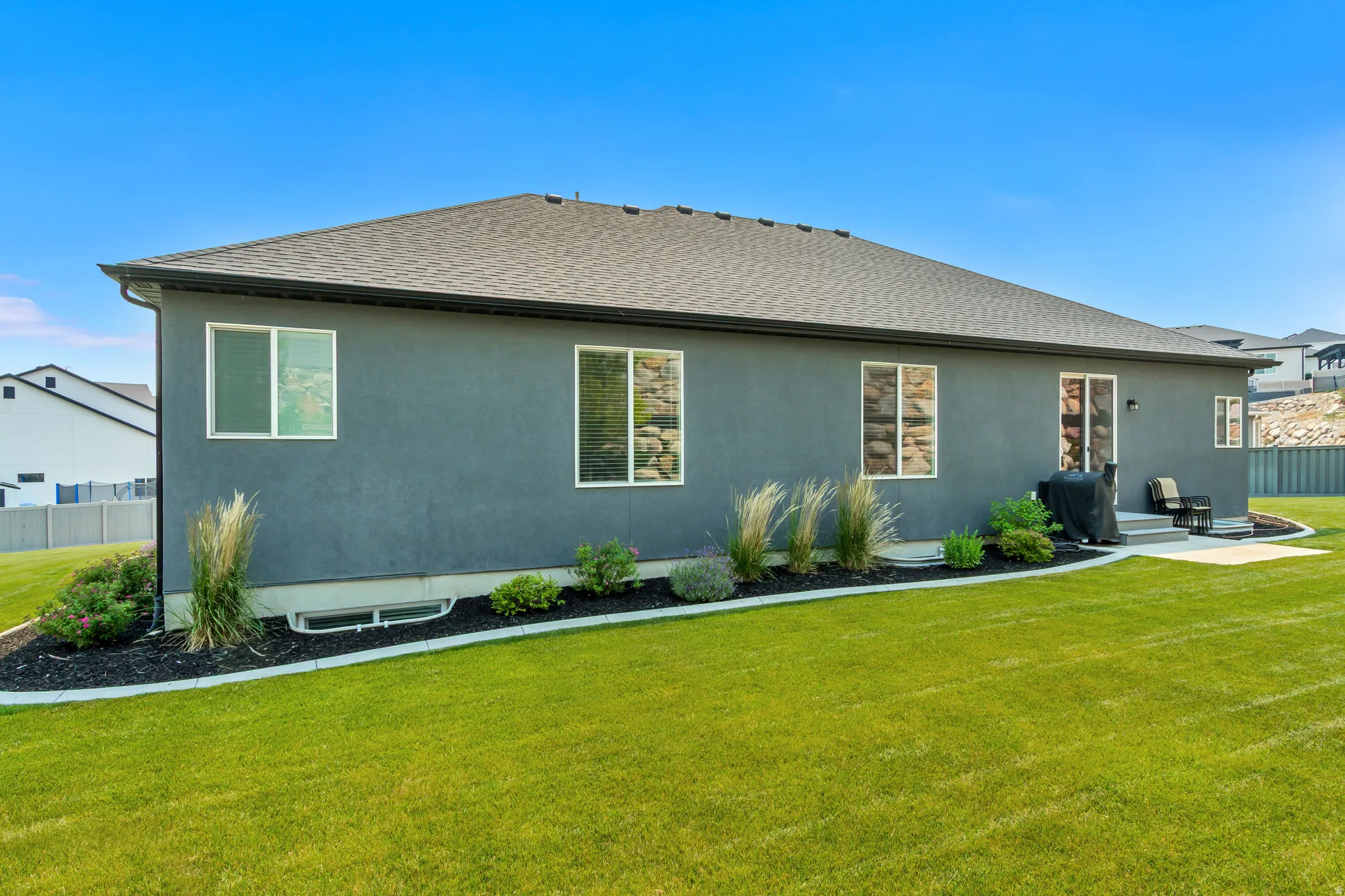 Expansive green lawn bordering the rear facade of the property