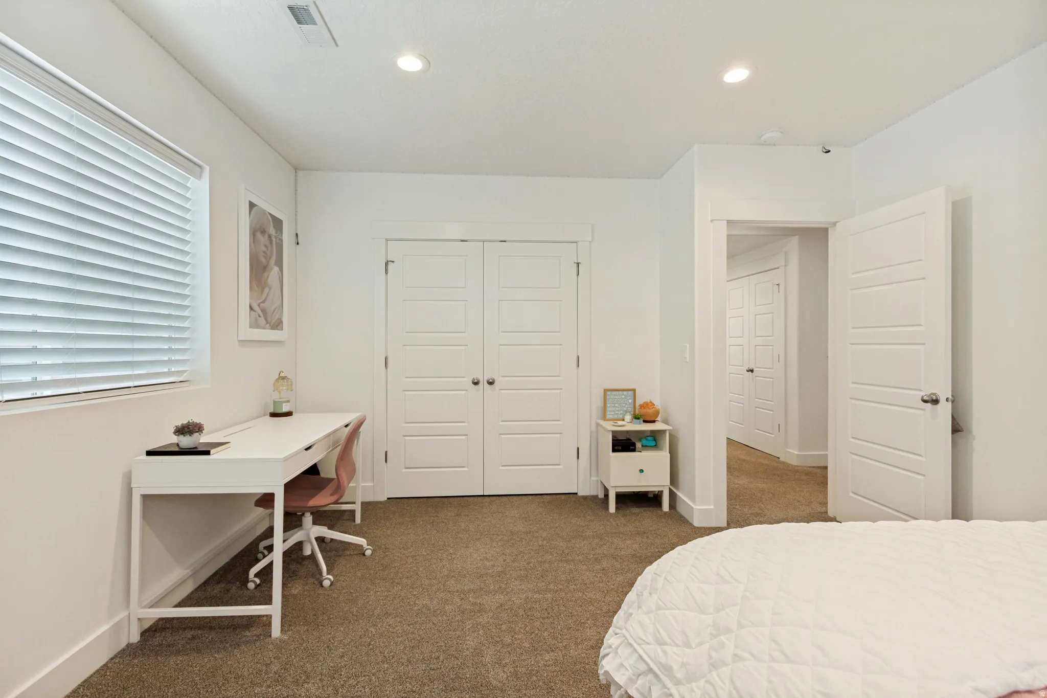 Carpeted interior space featuring white walls and trim