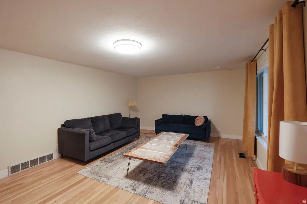 Light-toned walls complement wood-finish flooring in this living area