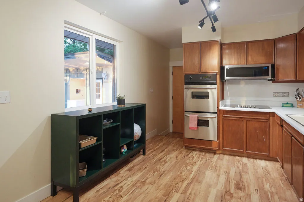 Kitchen featuring wood-finish flooring and a window providing natural light