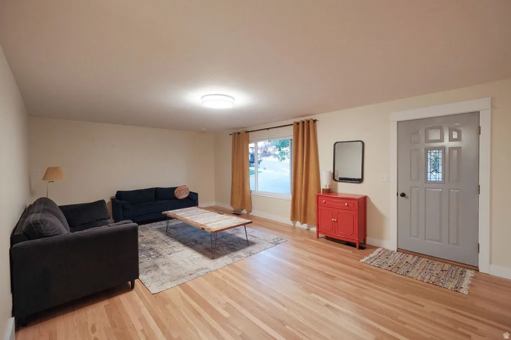 Entryway featuring a decorative front door with transom window, wood-finish flooring, and recessed lighting