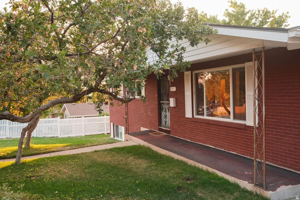 Brick exterior with white window shutters and a covered entry