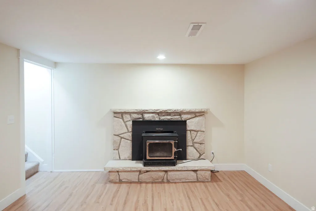 Stone-surround fireplace with hearth and wood-burning insert