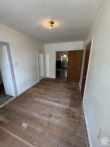 Hardwood flooring throughout, featuring a surface-mounted ceiling light fixture