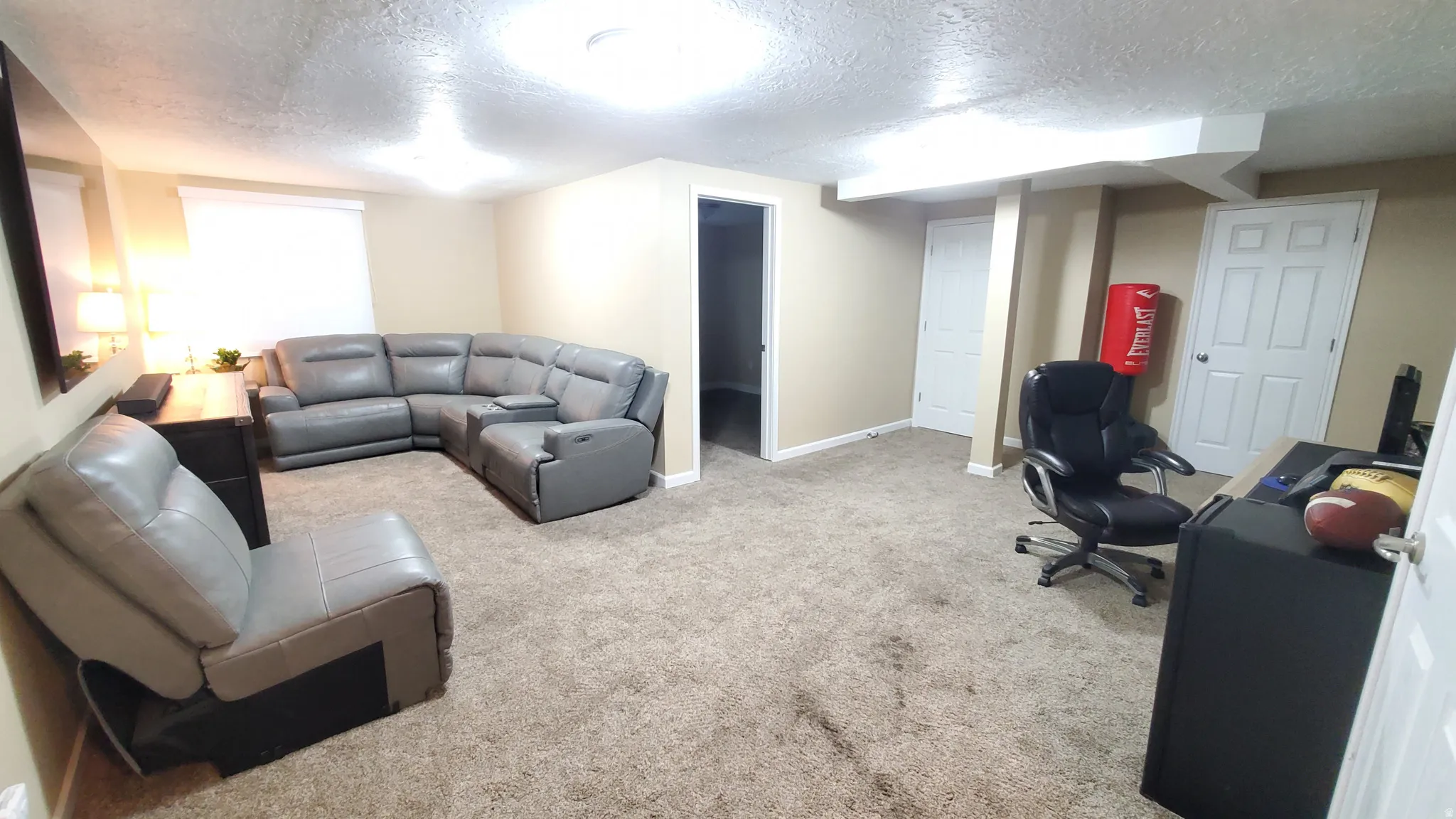 Carpeted room with neutral-toned walls, recessed lighting, and a drop ceiling