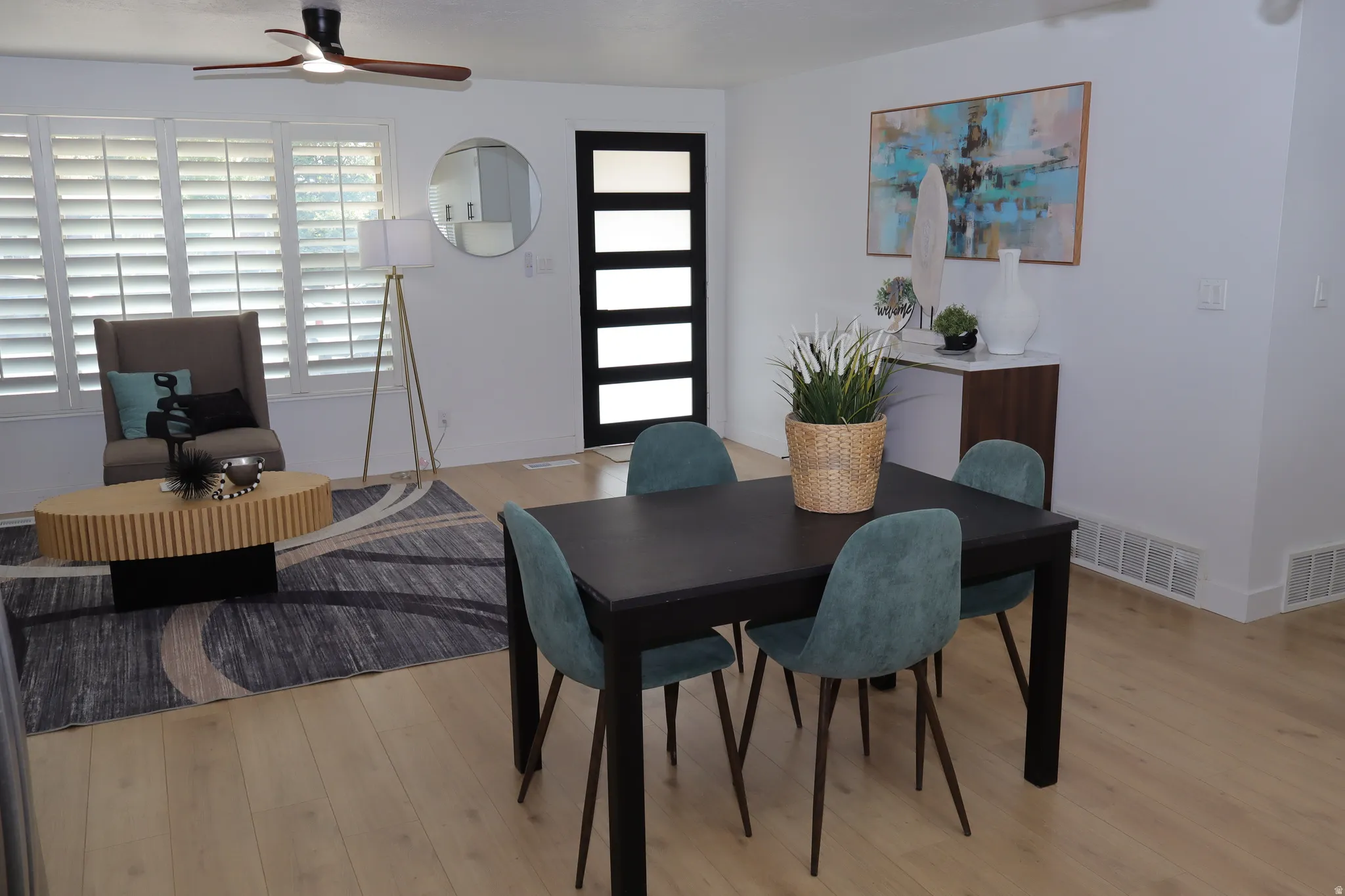 Open-concept living area with light wood-finish flooring