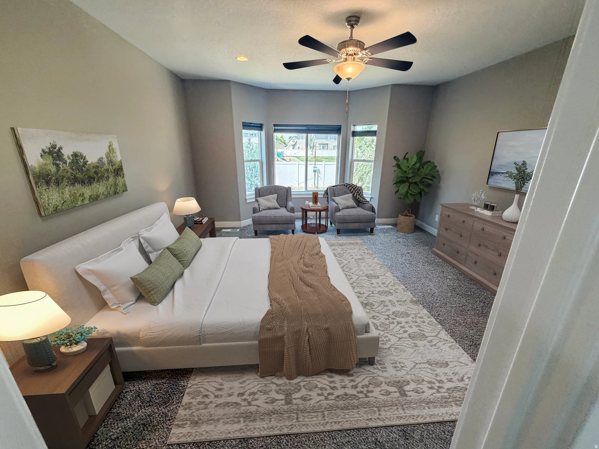 Spacious room featuring a bay window with multiple panes, recessed ceiling lighting, and a ceiling fan with integrated light fixture