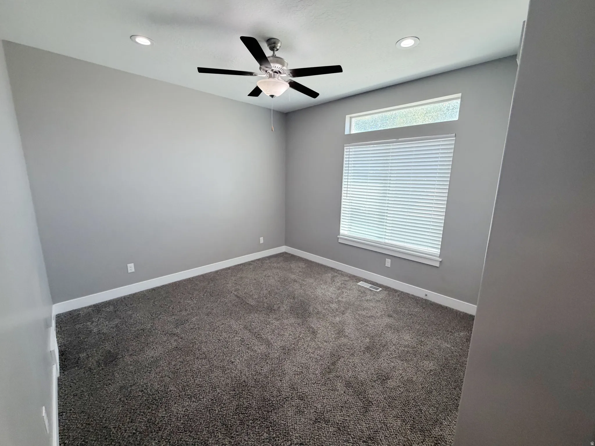 Neutral gray walls complemented by gray carpet flooring
