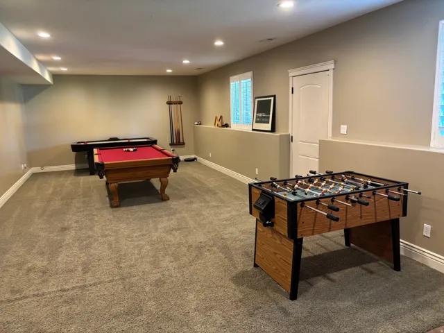 Finished basement featuring recessed lighting, a neutral color palette, carpeted flooring, and white trim