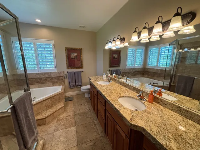 Expansive vanity featuring dual undermount sinks and a stone-finish countertop
