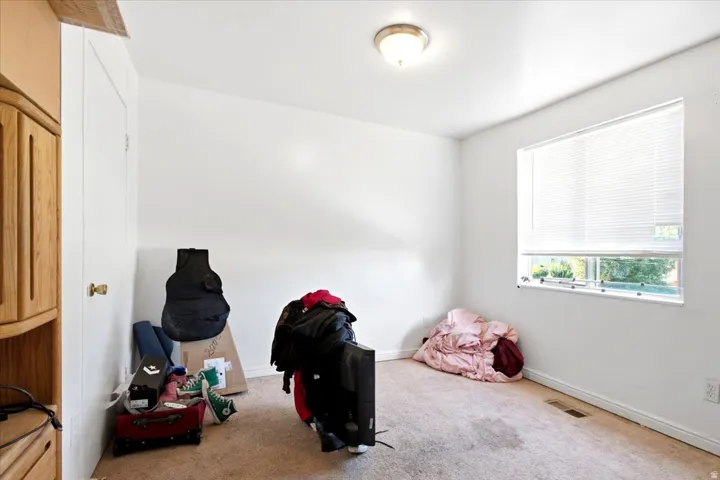 Room featuring light-colored walls and carpet flooring