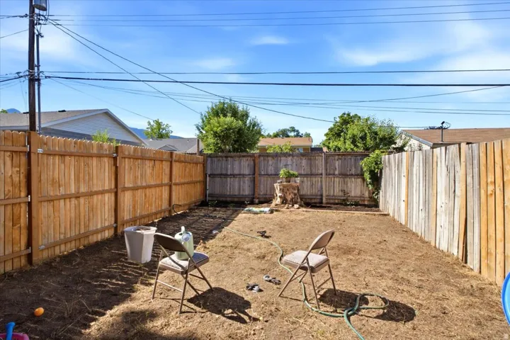 Enclosed backyard featuring wood privacy fencing along the perimeter