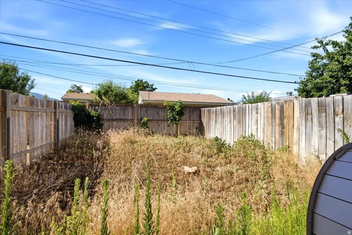 Fenced backyard with wood privacy fencing