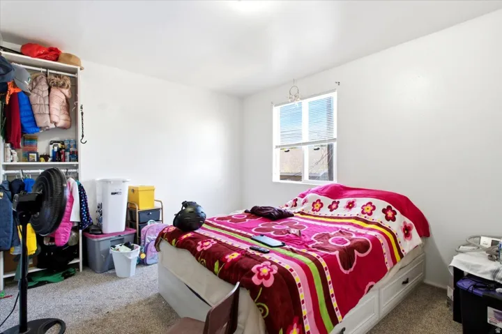 Bedroom featuring light-colored walls and carpeted flooring