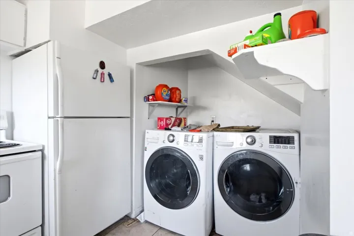 Dedicated laundry area featuring front-loading washer and dryer units