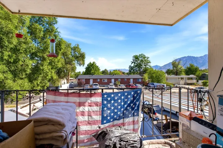Balcony featuring a metal railing and mountain scenery