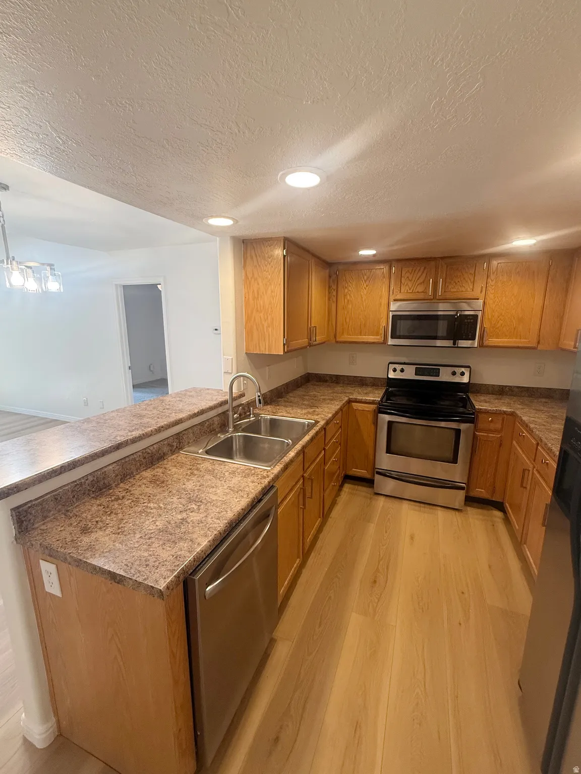 Kitchen featuring light wood cabinetry and wood-finish flooring