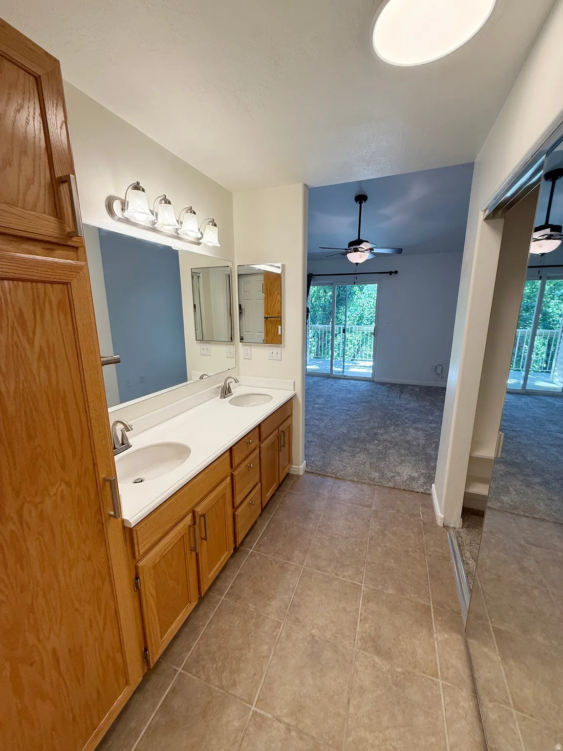 Dual vanity with integrated sinks and wood-finish cabinetry