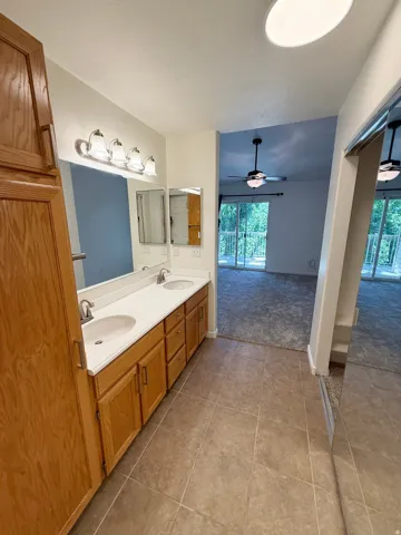 Dual vanity with integrated sinks and wood-finish cabinetry